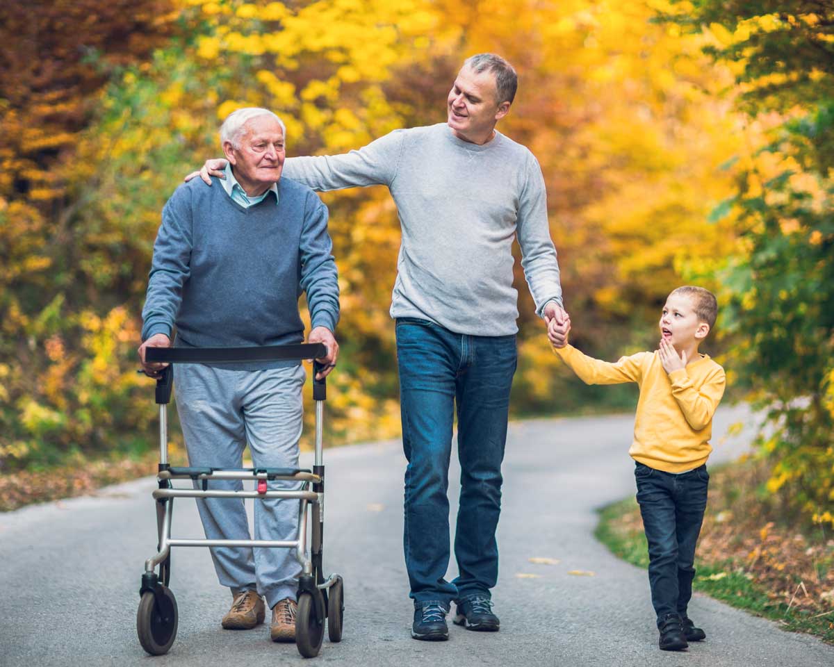 Senior man on a walk with his family during the fall