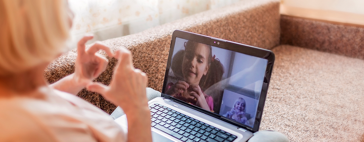 Senior woman talking to child over video chat