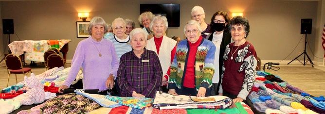 Quilters and knitters at Laurel Circle giving to charity