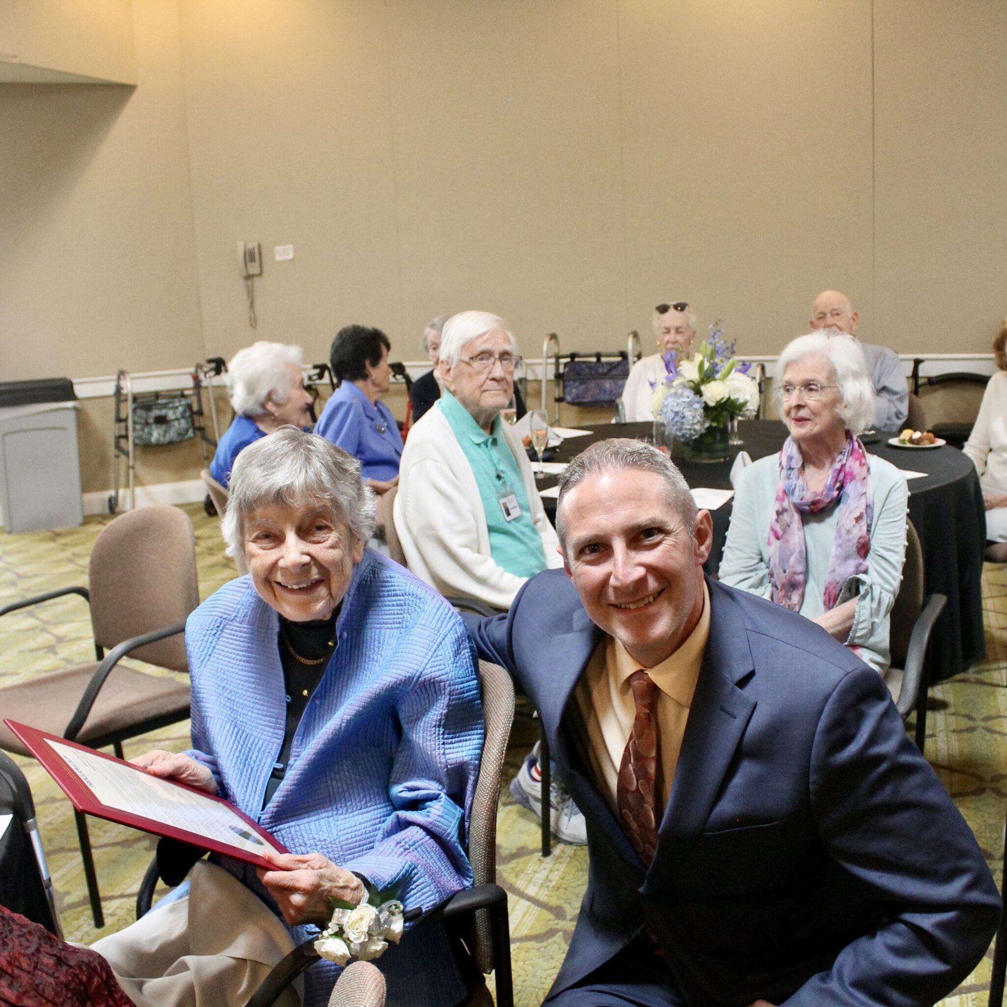 Mayor Matthew Moench posing with senior living community residents