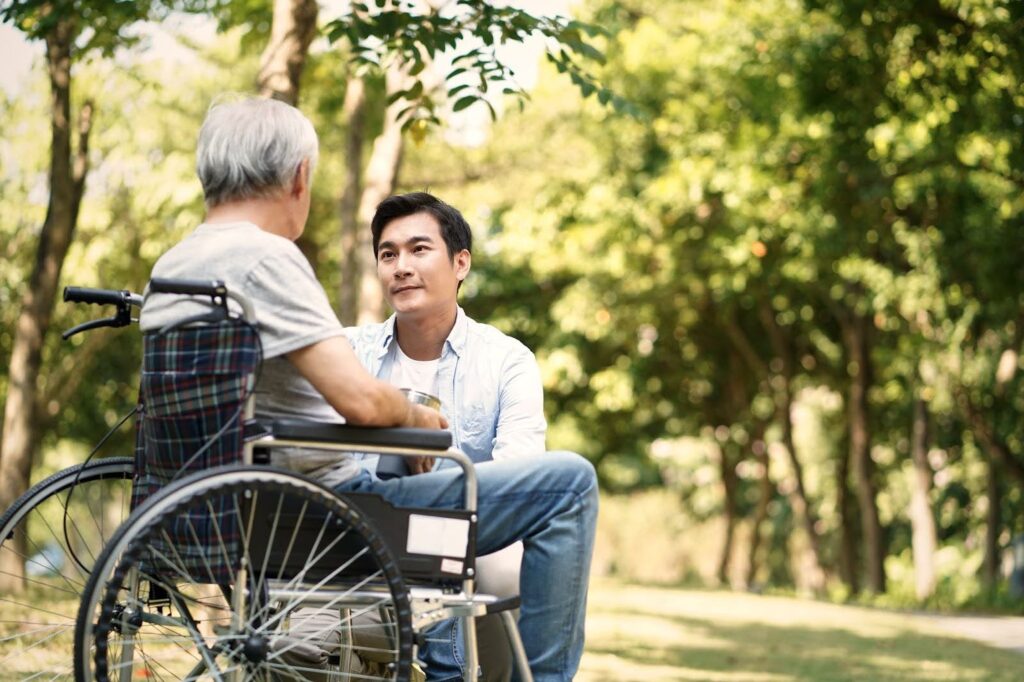 Man sitting with a senior woman in the park 